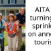 AITA for turning the sprinklers on annoying tourists?