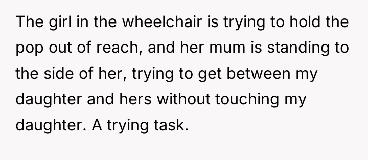 The girl in the wheelchair is trying to hold the...