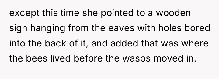 except this time she pointed to a wooden sign hanging...