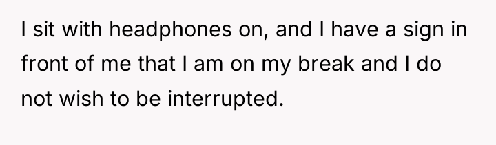 I sit with headphones on, and I have a sign...