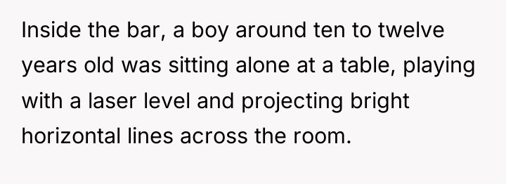 Inside the bar, a boy around ten to twelve years...