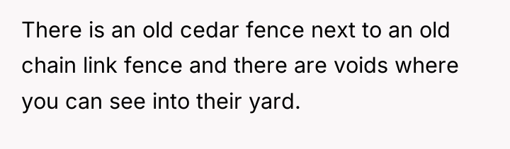 There is an old cedar fence next to an old...